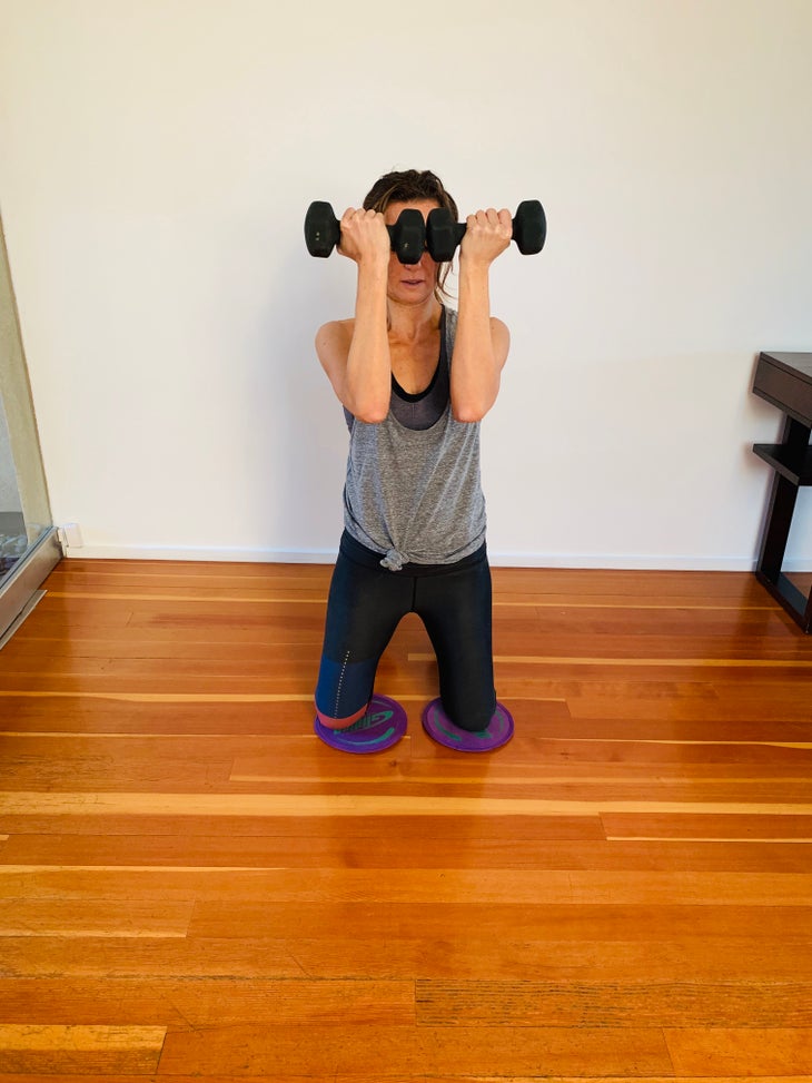 Arnold Press 1 fit woman doing an arnold press