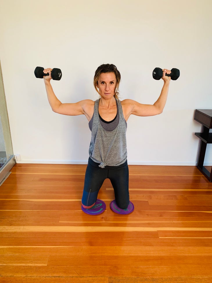 Arnold Press 2 fit woman doing an arnold press
