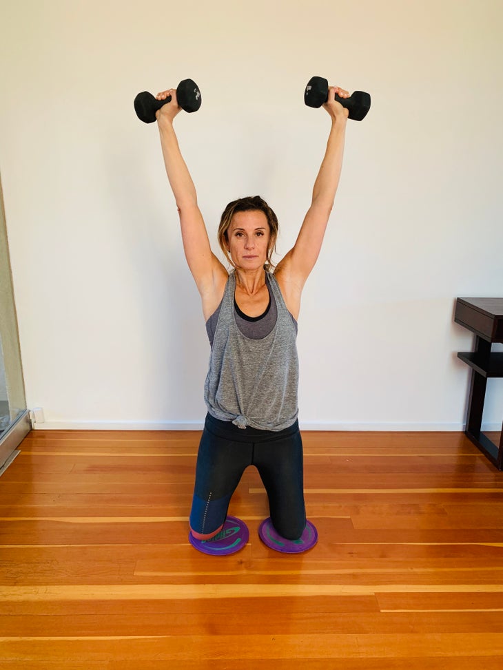 Arnold Press 3 fit woman doing an arnold press