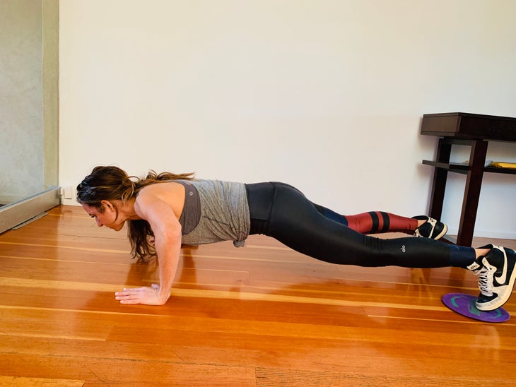 Pike To Push Up 1 fit woman doing a pike to push-up