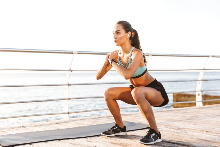 shutterstock_1130977049 Woman squatting outdoors