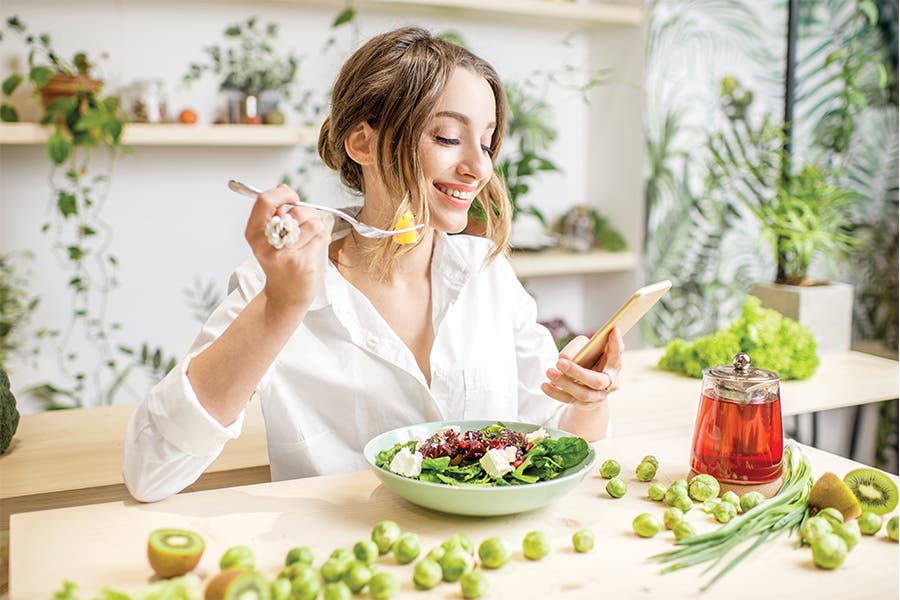 Counting Calories Woman eating veggies and counting calories