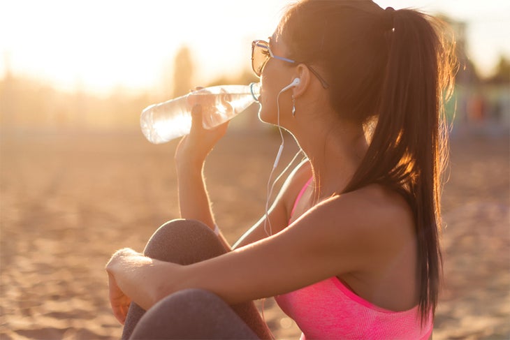 Preworkout Fit woman drinking water