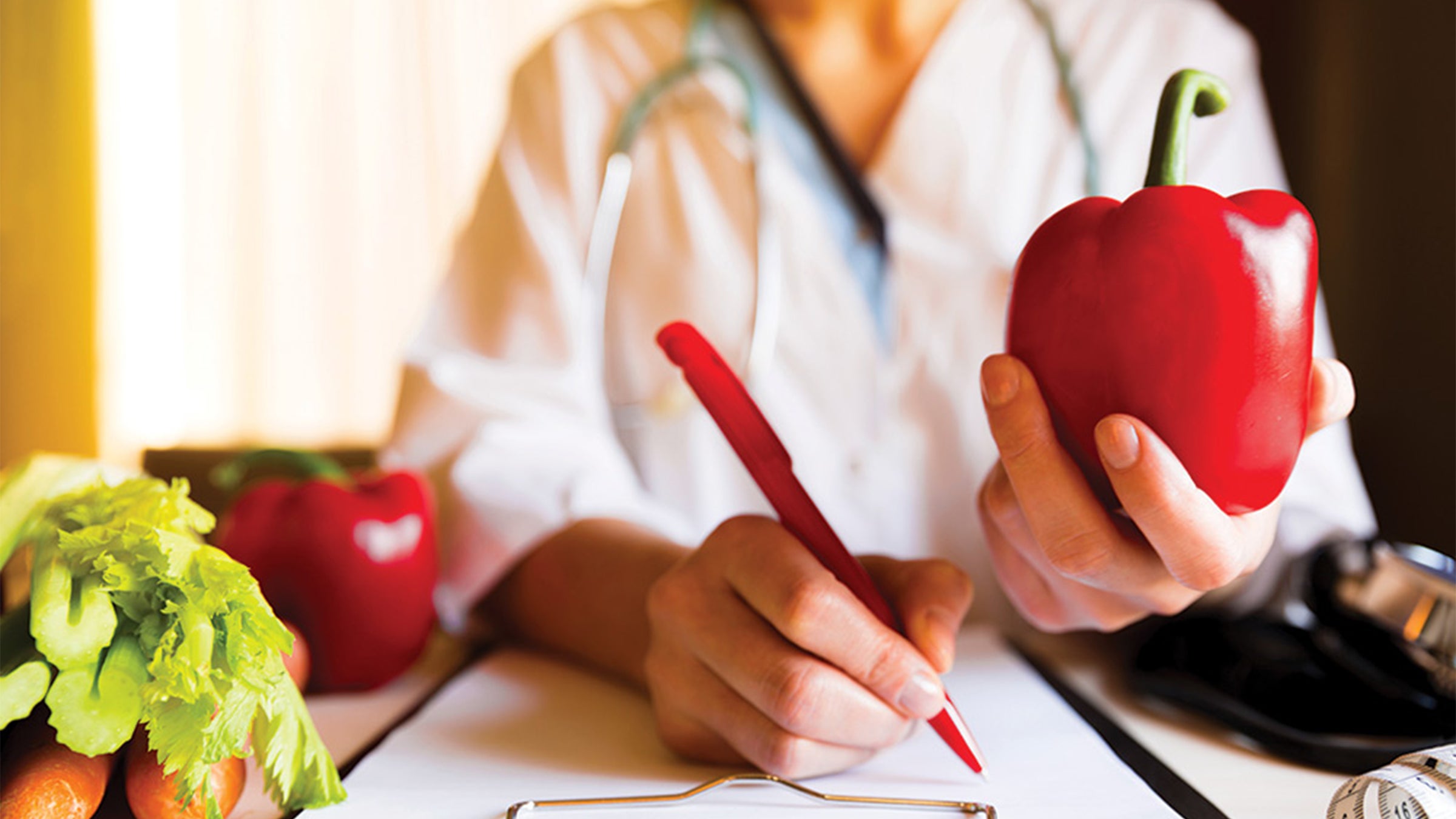 Doctor/nutritionist taking notes.