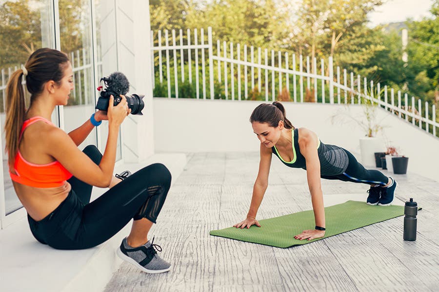 female fitness influencers filming workouts