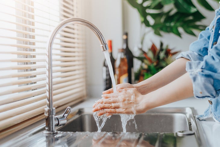 Wash Hands Woman washing her hands in the kitchen