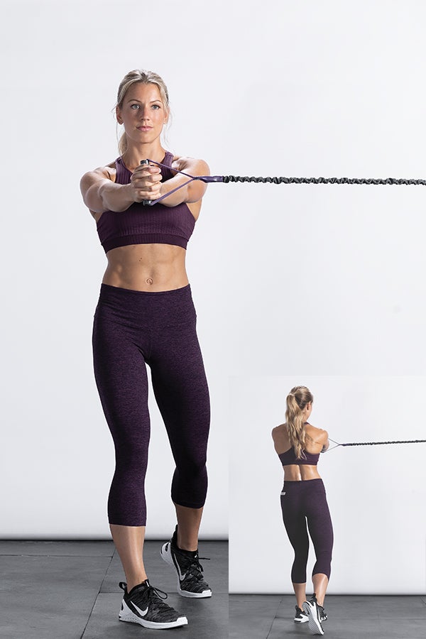 Rotate Woman doing a resistance band rotation - functional training