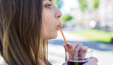 Woman drinking a smoothie to beat soreness