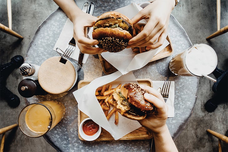 Eating Hamburgers Two people eating burgers
