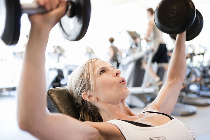 Woman Lifting Weights Woman breathing while strength training