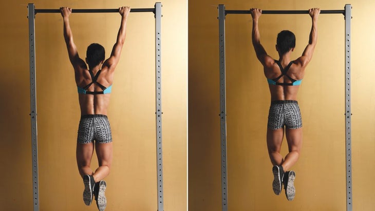 Fit woman preparing for the pull-ups on the horizontal bar Stock