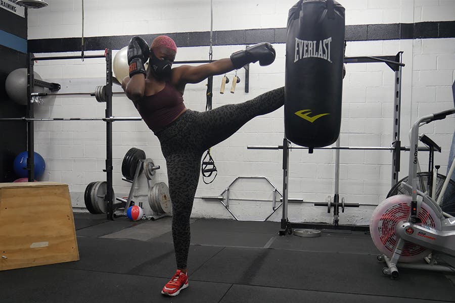 Danielle Duffy kickboxing while wearing her training mask