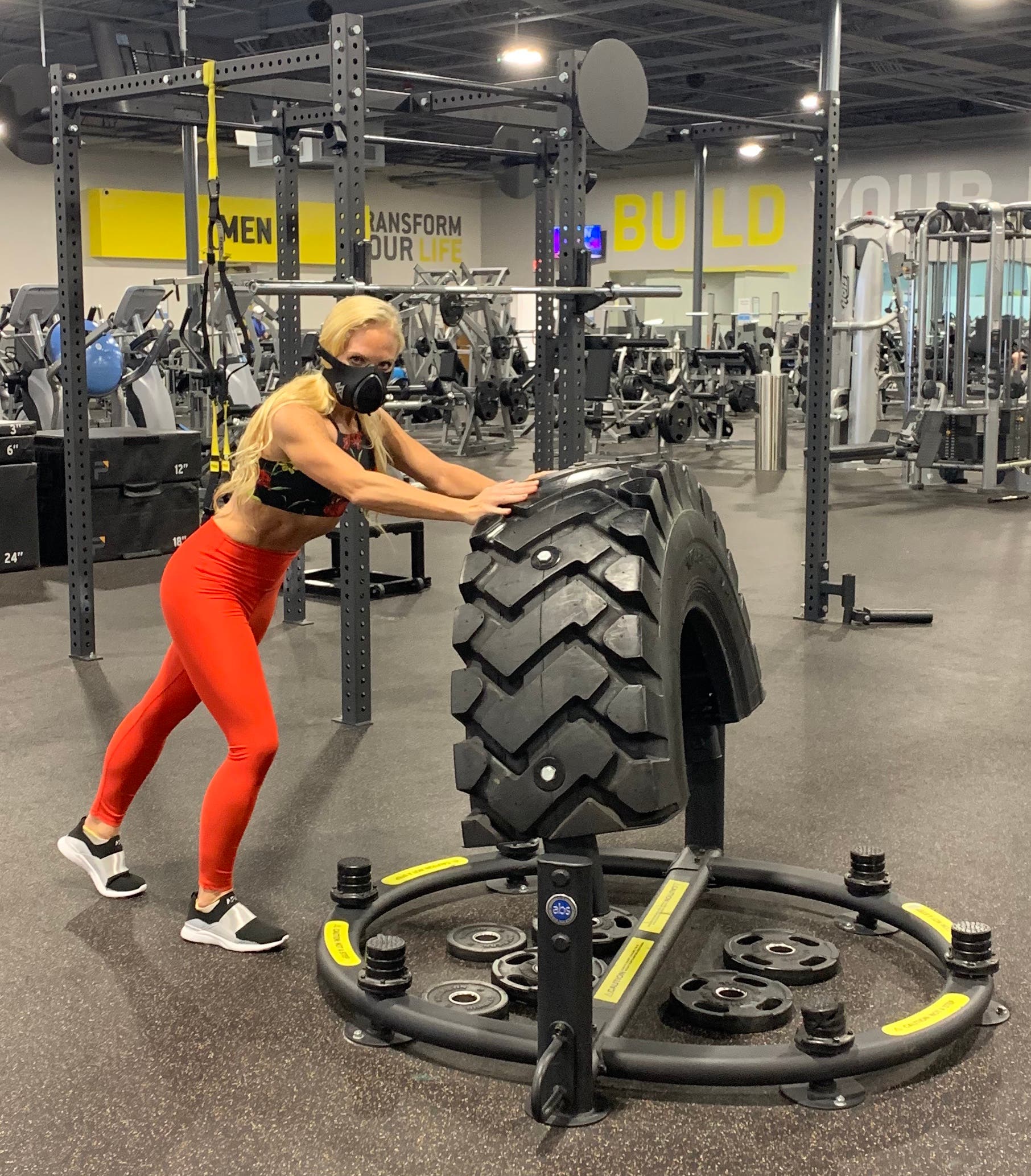 Madeline wearing the training mask 3.0 while tire flipping