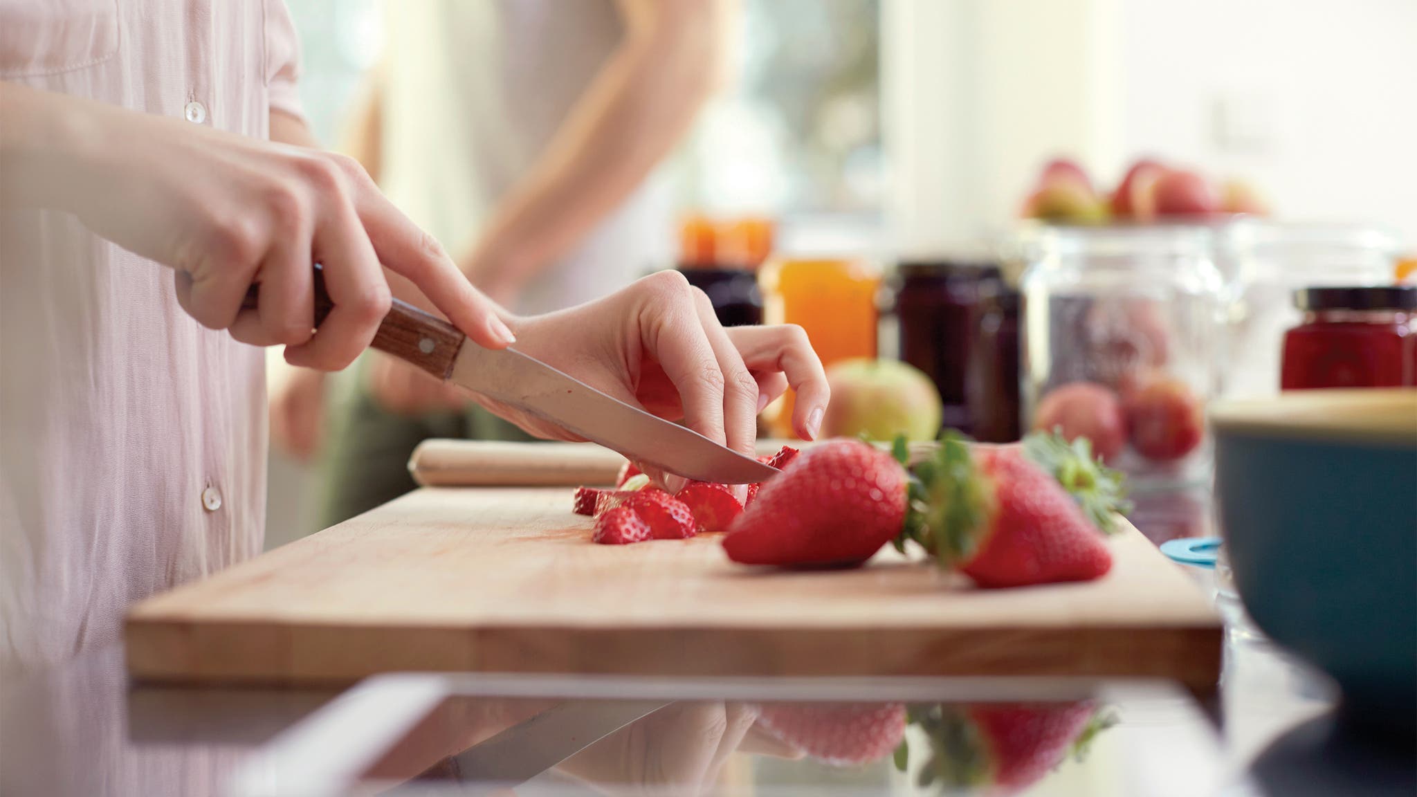 Woman slicing strawberries