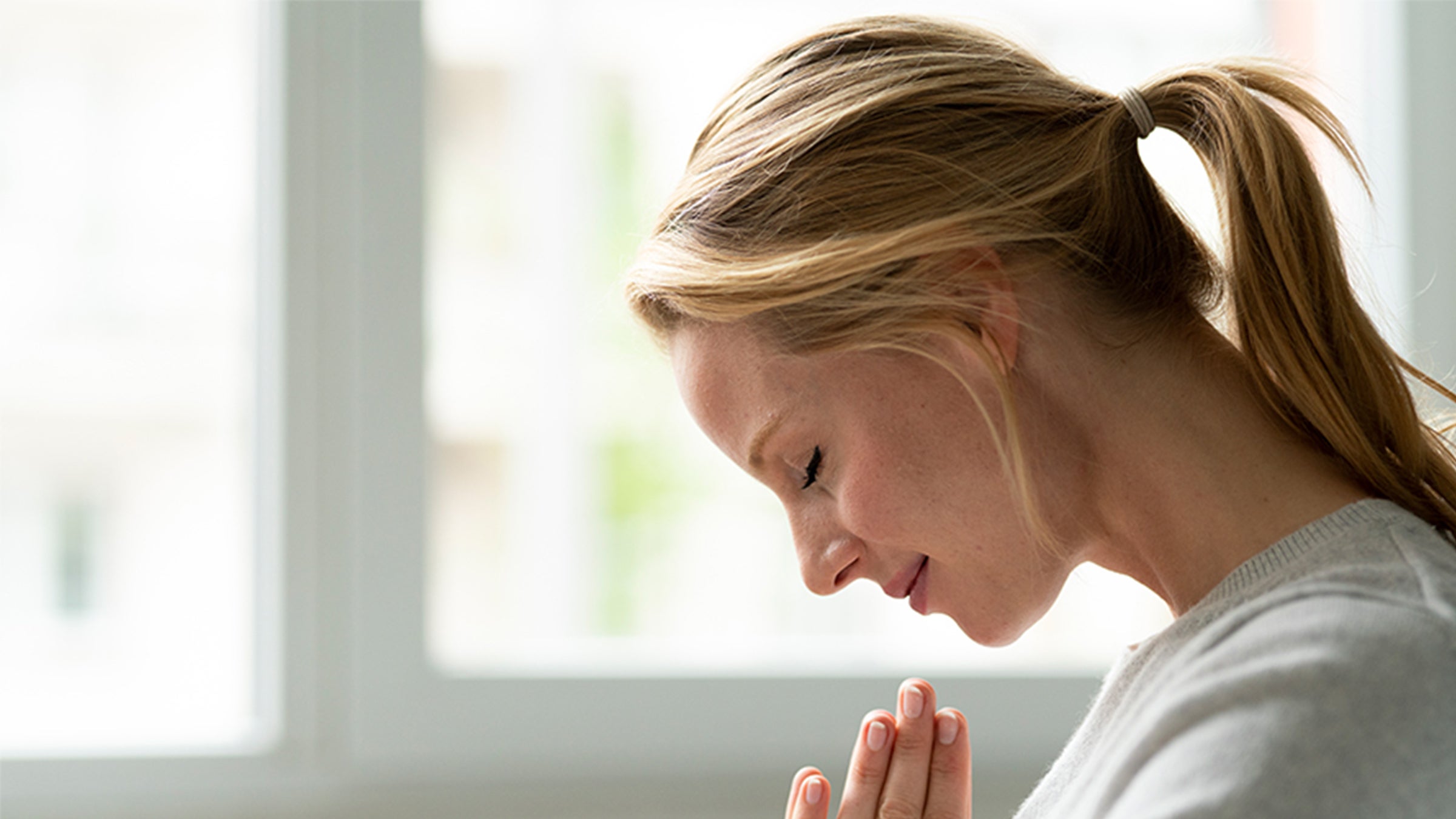 Woman focusing while meditating in prayer.