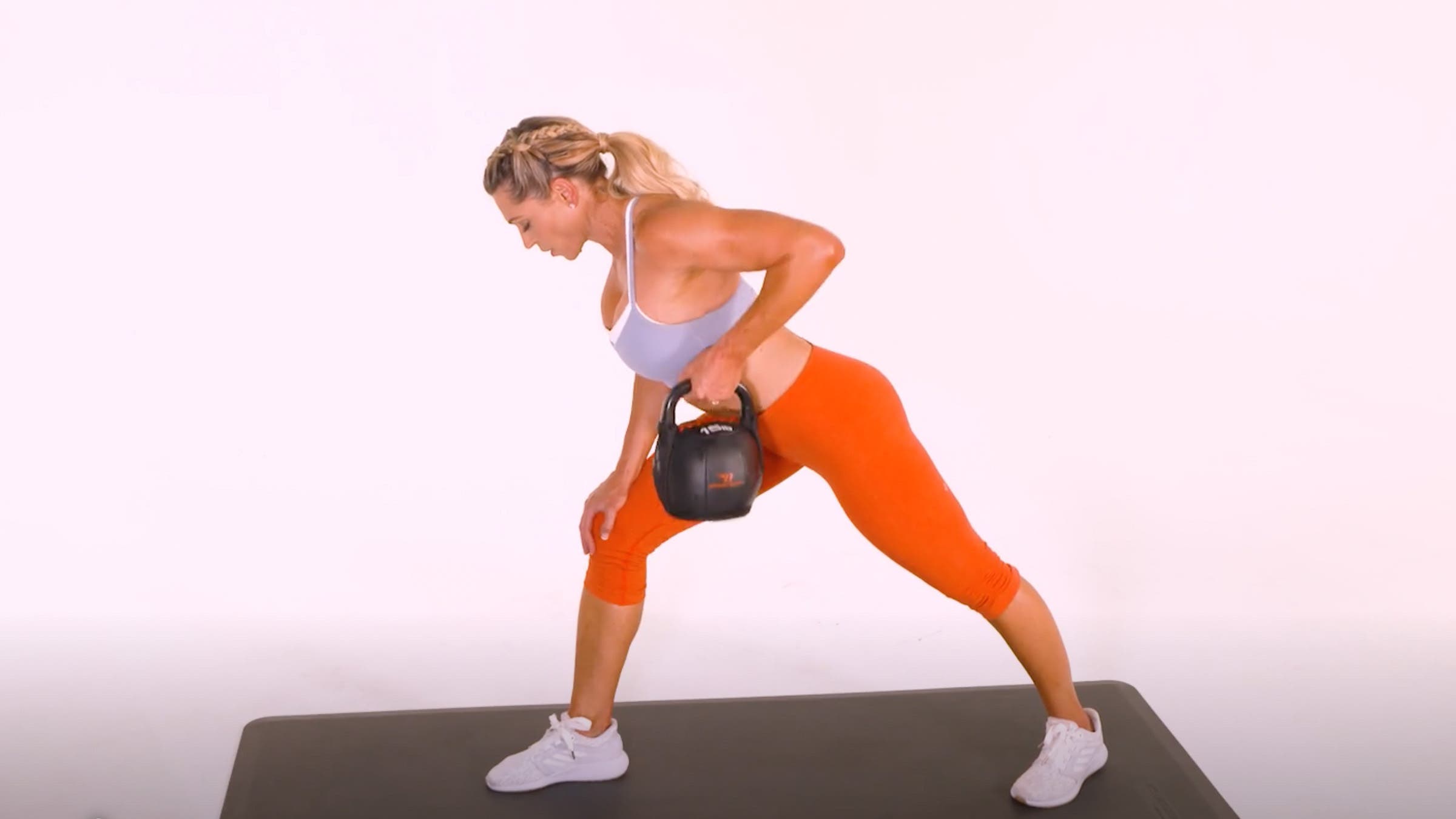 Woman demonstrating Kettlebell One-Arm Bent-Over Row
