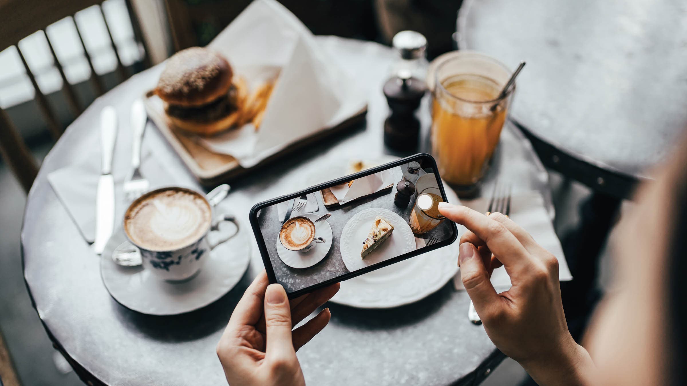 Person taking a photo of their food from their smartphone
