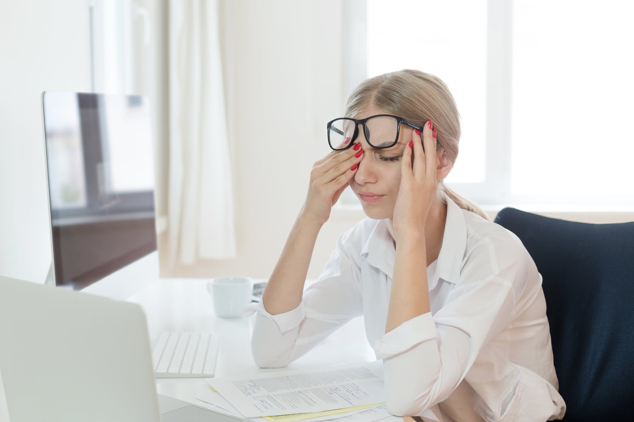 Tired woman rubbing eyes