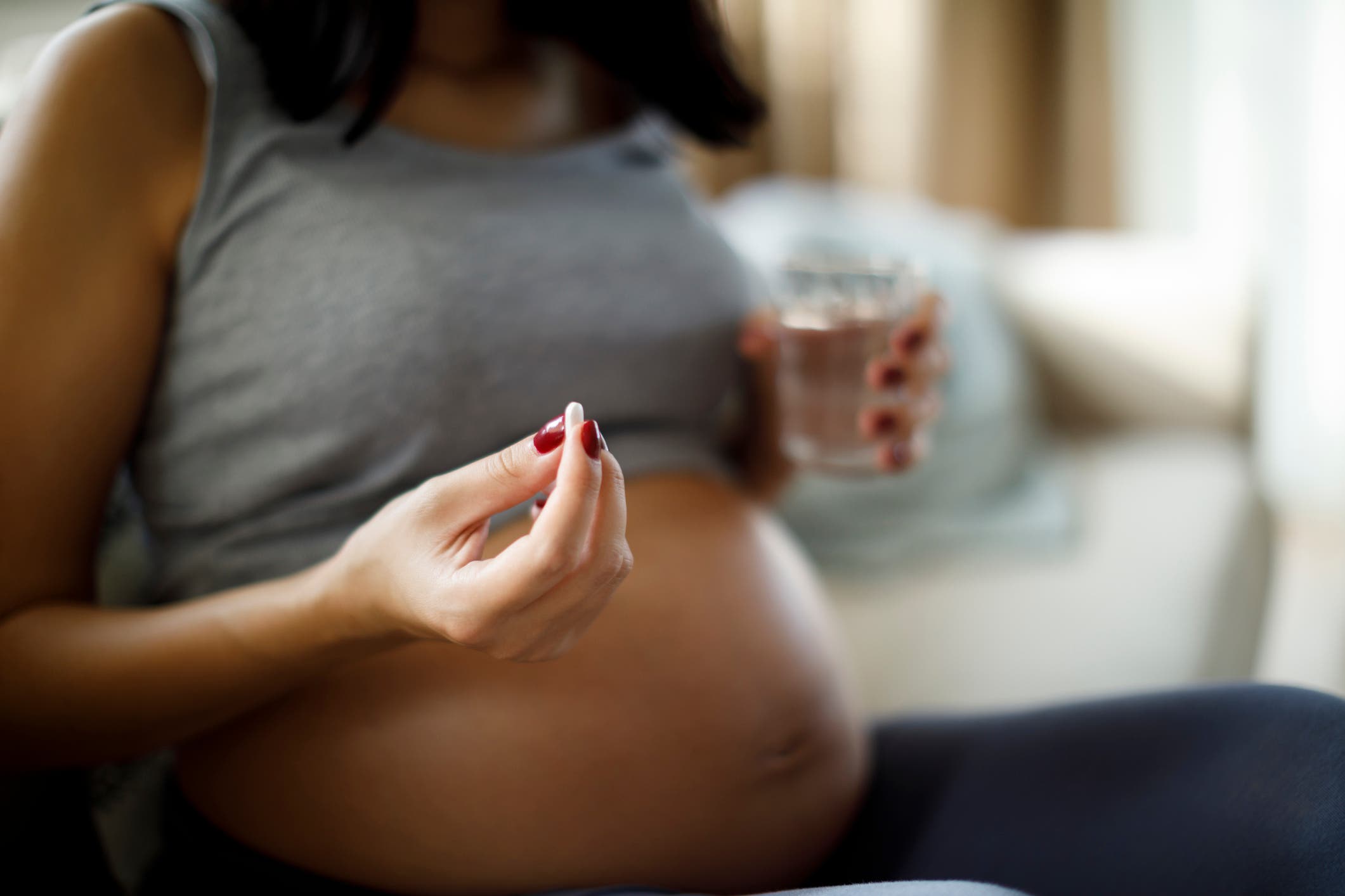 Pregnant woman taking pill